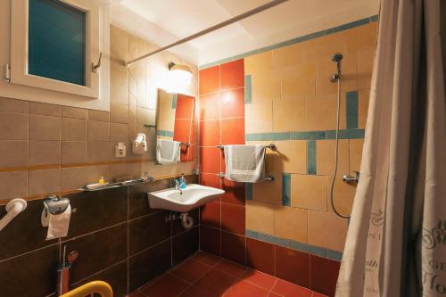 a bathroom with a sink and a shower at Hotel Villa Sevasti in Katerini