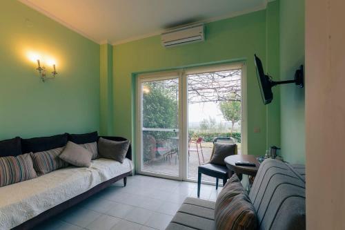 a living room with a couch and a window at Hotel Villa Sevasti in Katerini