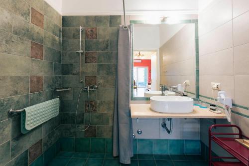 a bathroom with a sink and a shower at Hotel Villa Sevasti in Katerini