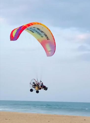 a kite flying in the air over the beach at Beach Wave Hotel in Arugam Bay