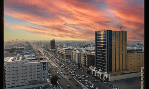 a view of a city with cars on a highway at Dancenter Jeddah Near King Fahd's Fountain in Jeddah