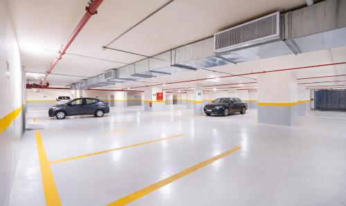 two cars parked in an empty parking garage at Dancenter Jeddah Near King Fahd's Fountain in Jeddah