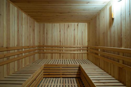 an empty wooden sauna with wooden floors and ceilings at Dancenter Jeddah Near King Fahd's Fountain in Jeddah