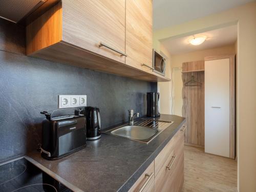 a kitchen with a sink and a microwave at Ferienhaus in Thüringen mit Garten in Mosbach