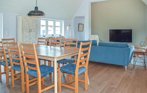 a dining room and living room with a table and chairs at 3 Bedroom Lovely Home In Hammenhög in Hammenhög