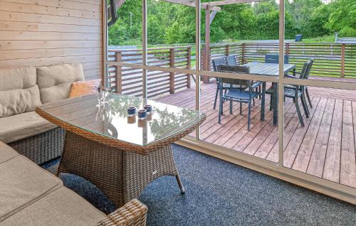 a patio with a table and chairs on a deck at Stunning Home In Asarum With Wifi in Asarum