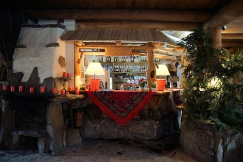 a bar inside of a house with a red cloth at Noclegi Styrnol & SPA in Zawoja