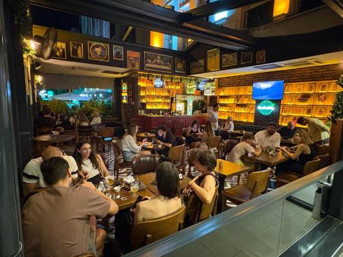 a group of people sitting at tables in a restaurant at CK Farabi Hotel in Ankara