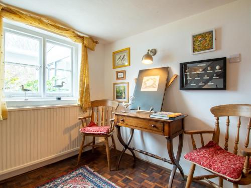 a home office with a desk and two chairs at Highlands Farmhouse in Dallington