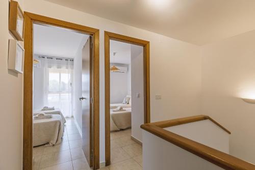 a hallway with a door leading to a living room at El Velero in El Tosalet