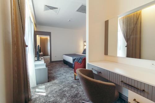 a hotel room with a mirror and a bed at CK Farabi Hotel in Ankara