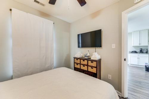 a bedroom with a bed and a flat screen tv at Jacksonville Home By Camp Lejeune, Beaches and More! in Jacksonville