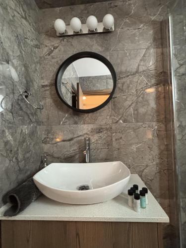 a bathroom with a white sink and a mirror at Luca Apts Napa in Ayia Napa