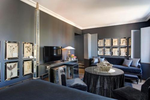 a living room with a couch and a table at The Franklin London - Starhotels Collezione in London