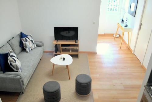 a living room with a couch and a table at Refúgio da Luz in Lisbon