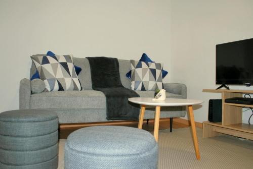 a living room with a couch and a table at Refúgio da Luz in Lisbon