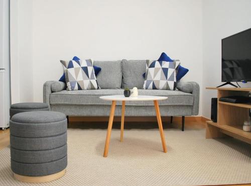 a living room with a couch and a coffee table at Refúgio da Luz in Lisbon