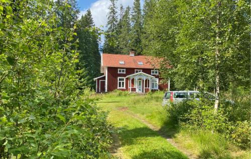 a house with a car parked in front of it at Stunning Home In Skillingaryd With Sauna in Ryd