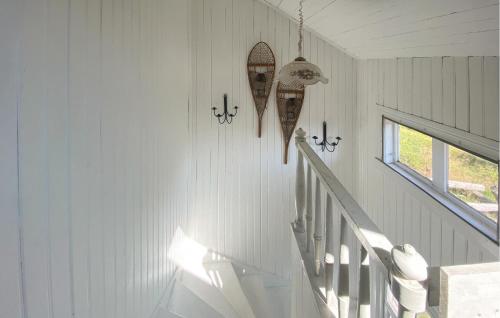 a hallway with white walls and white stairs with a mirror at Stunning Home In Skillingaryd With Sauna in Ryd