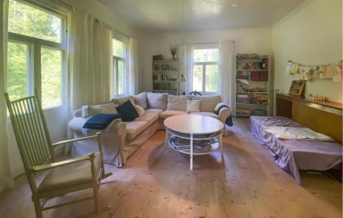 a living room with a couch and a table at Stunning Home In Skillingaryd With Sauna in Ryd