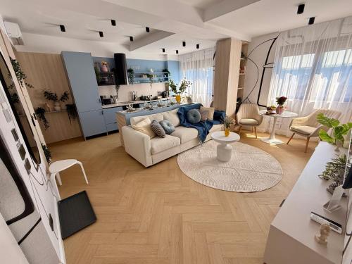 a living room with a couch and a kitchen at AIASTAY Bucharest River Apartments in Bucharest