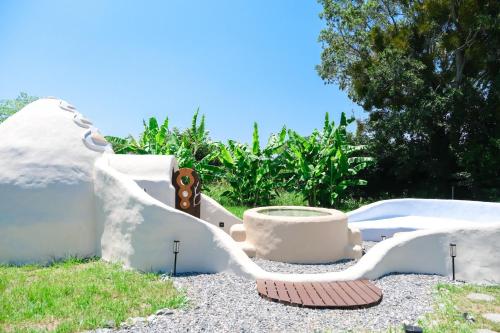 a pot sitting on the ground in a garden at Rosh - Private Sauna & Traditional Japanese House in Tateda