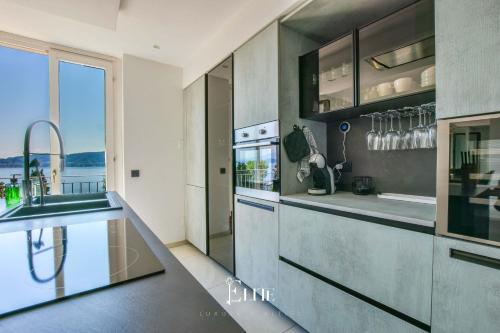 a kitchen with a sink and a counter top at Lake Maggiore View Apt Meina in Meina