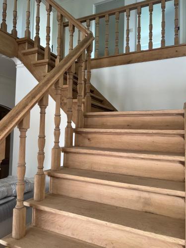 a staircase with wooden treads in a home at Maison François in Oostkamp
