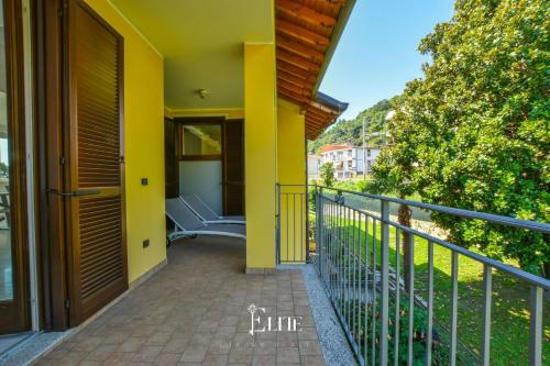 a balcony of a house with a yellow wall at Lake Maggiore View Apt Meina in Meina