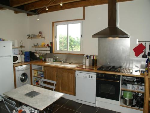 a kitchen with a sink and a stove top oven at Nature Escape in Loubressac in Loubressac