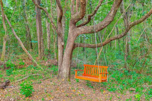 a orange bench sitting next to a tree at 2 Mi to Bay and Beaches Home with Gazebo in Daphne in Daphne