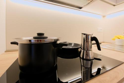a coffee pot sitting on top of a stove in a kitchen at Alpine Escape 1BR Apartment A in Tarvisio