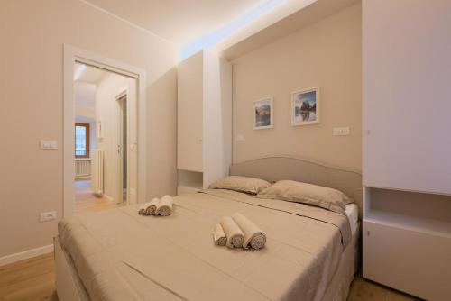 a bedroom with a large bed with two towels on it at Alpine Escape 1BR Apartment A in Tarvisio