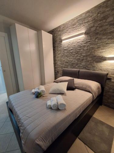 a bed with three towels on it in a bedroom at Matteo Lago in Sale Marasino
