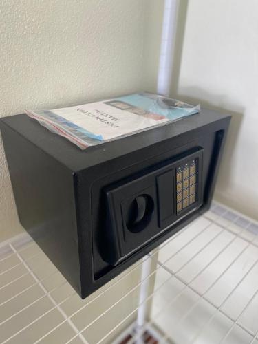 a microwave with a book on top of it at Muttafa House in Nai Yang Beach