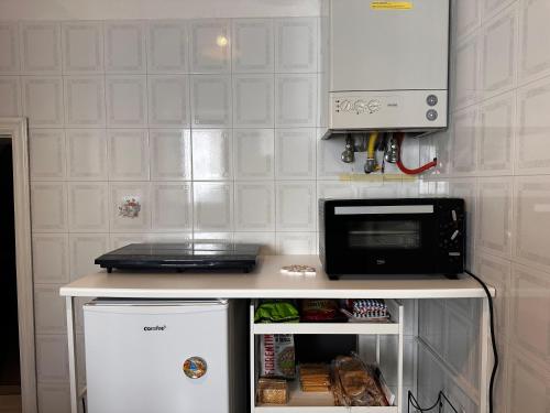 a small refrigerator with a microwave on top of it at Tenuta Moffa in Tramonti
