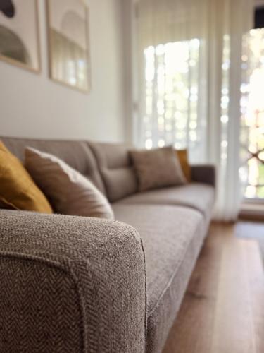 a couch sitting in a living room with at Apartman Green Divčigora in Divčibare