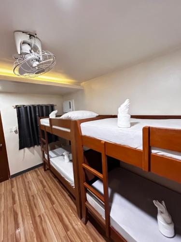 a room with two bunk beds and a light at Vestra Alona Guest House in Panglao