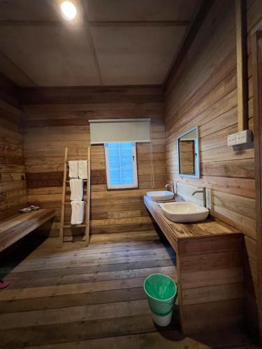 a wooden bathroom with a sink and a tub at Sisipan Island Resort in Semporna