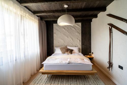 a bedroom with a bed and a large window at Avalanche Chalet in Poiana Brasov