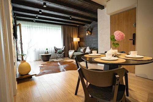 a living room with a table and chairs in a room at Avalanche Chalet in Poiana Brasov