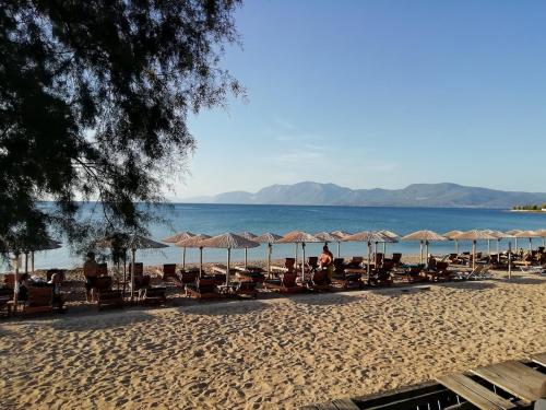 a group of chairs and umbrellas on a beach at Lovely house with amazing views in Kánithos