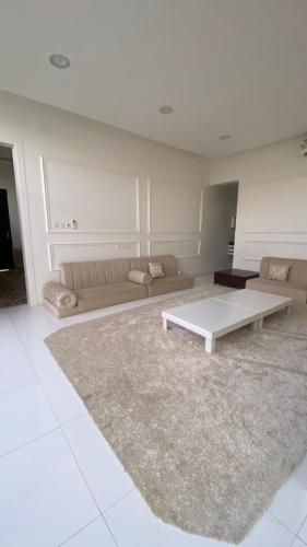 a living room with a couch and a coffee table at شاليه الروضه in Al Rass