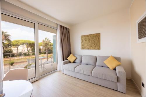 a living room with a couch and a large window at Hotel Viareggio in Viareggio