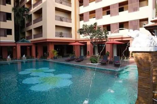 a large swimming pool in front of a building at Palette Luxe North Pattaya in Pattaya North