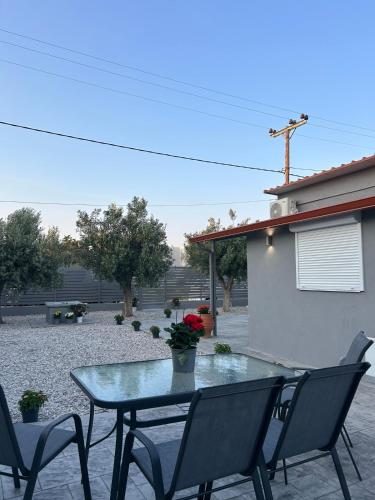 a table and chairs sitting on a patio at MtsHome in Áyios Spirídhon