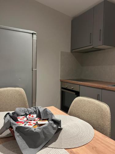 a kitchen with a table with chairs and a refrigerator at MtsHome in Áyios Spirídhon