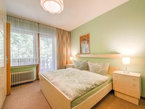 a bedroom with a bed and a large window at Geräumiges Apartment am Waldrand im Sauerland in Medebach