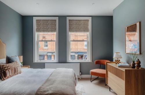 a bedroom with a bed and two windows at The Castle in Newcastle