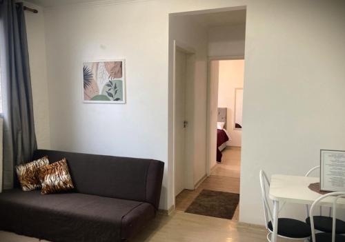 a living room with a couch and a table at Apartamento em Gravataí in Gravataí